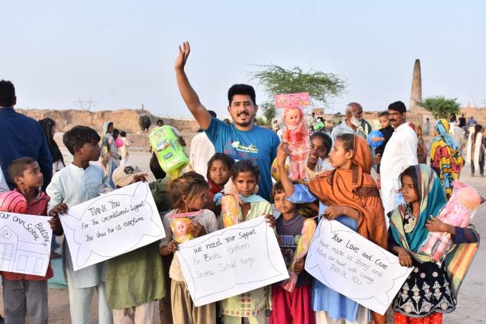 Young man holding toys for children - image 3
